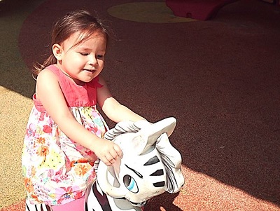 a blind child rocking on a rocking horse